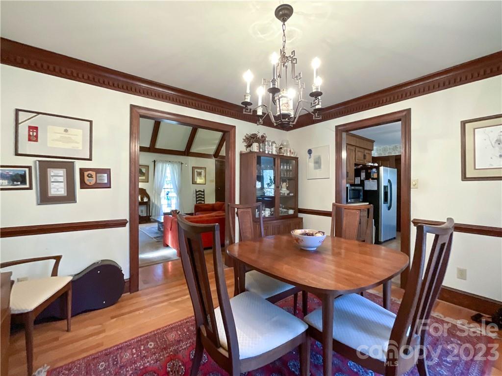 9523 Marvin School Road Marvin, NC 28173 - Photo 10 of 47 a view of a dining room with furniture a chandelier and wooden floor