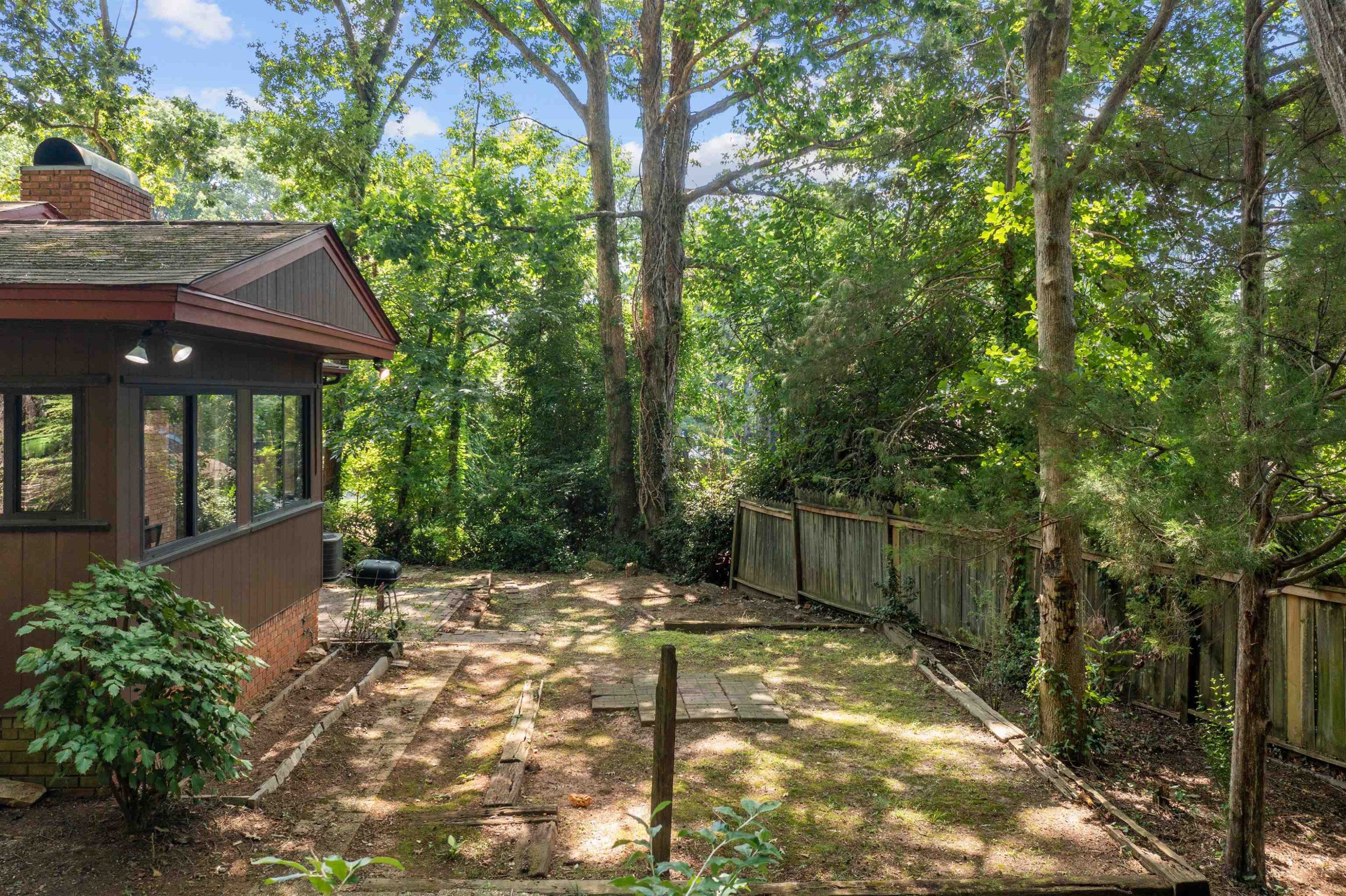 3207 Cyanne Circle Raleigh, NC 27606 - Photo 11 of 43 The sunrooms looks out over the wooded back yard. This home is an entertainer's dream! Exterior back