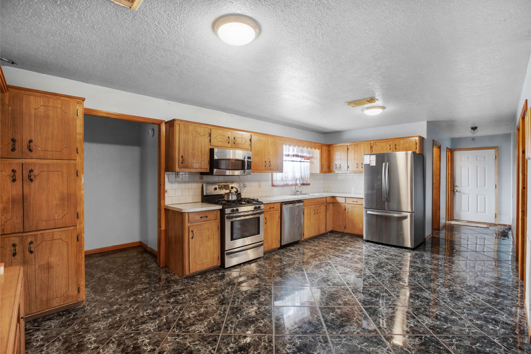 14205 Bohemian Hall Road Crosby, TX 77532 - Photo 2 of 33 a kitchen with stainless steel appliances granite countertop a refrigerator a stove a sink a washer dryer and a refrigerator