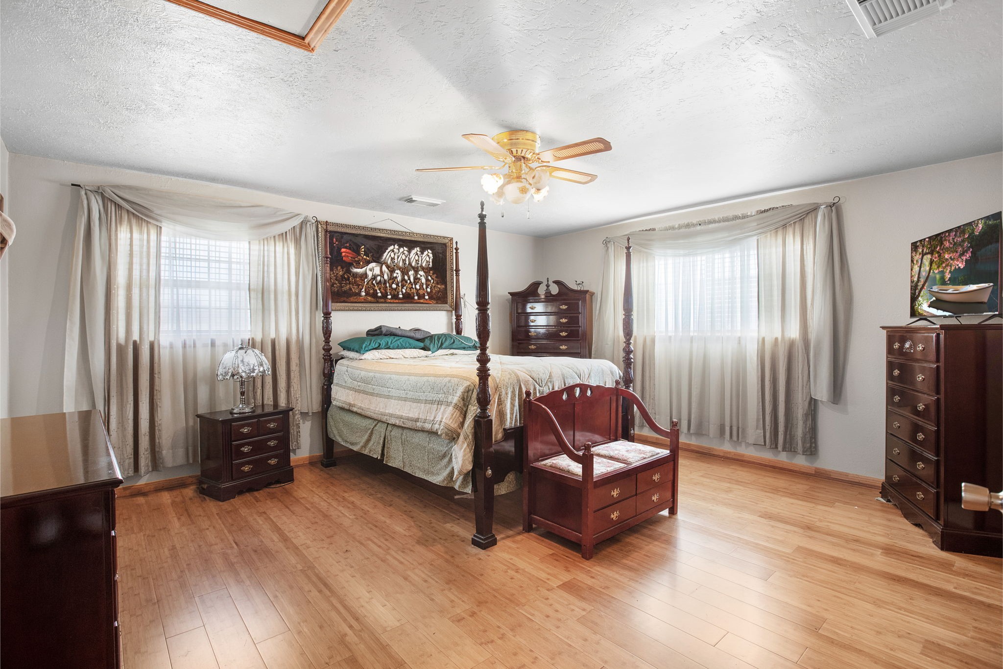 14205 Bohemian Hall Road Crosby, TX 77532 - Photo 10 of 33 a bedroom with furniture and a flat screen tv