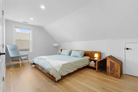 a bedroom with furniture and a wooden floor