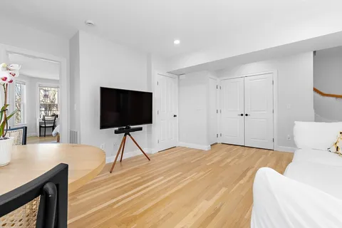 a dining room with furniture and wooden floor