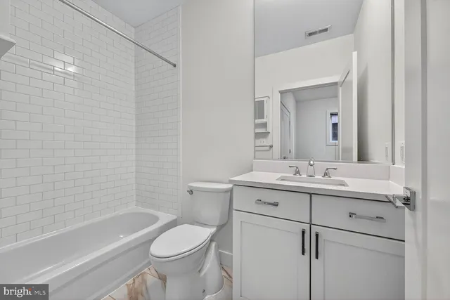 a bathroom with a sink a toilet and a bathtub