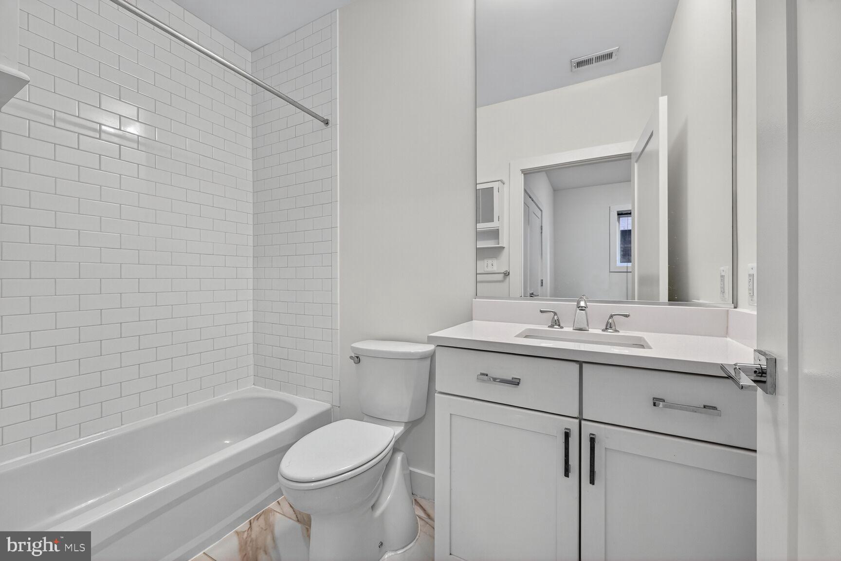 1412 Chapin Street Northwest, Unit 2 Washington, DC 20009 - Photo 12 of 15 a bathroom with a sink a toilet and a bathtub