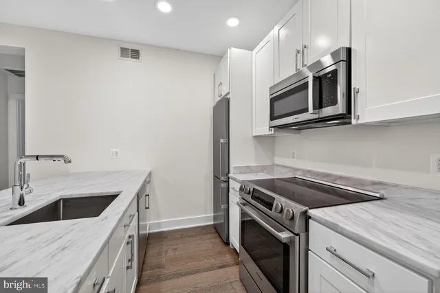 a kitchen with a sink stove and microwave