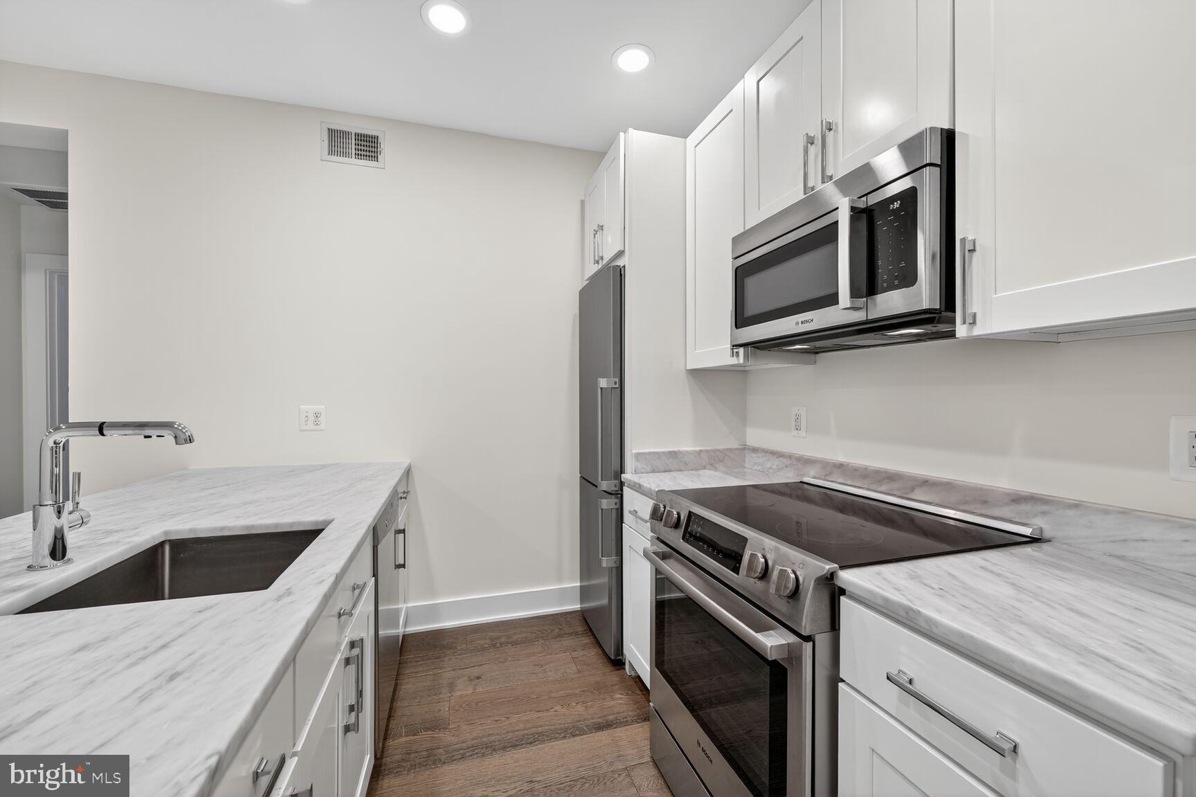 1412 Chapin Street Northwest, Unit 2 Washington, DC 20009 - Photo 3 of 15 a kitchen with a sink stove and microwave