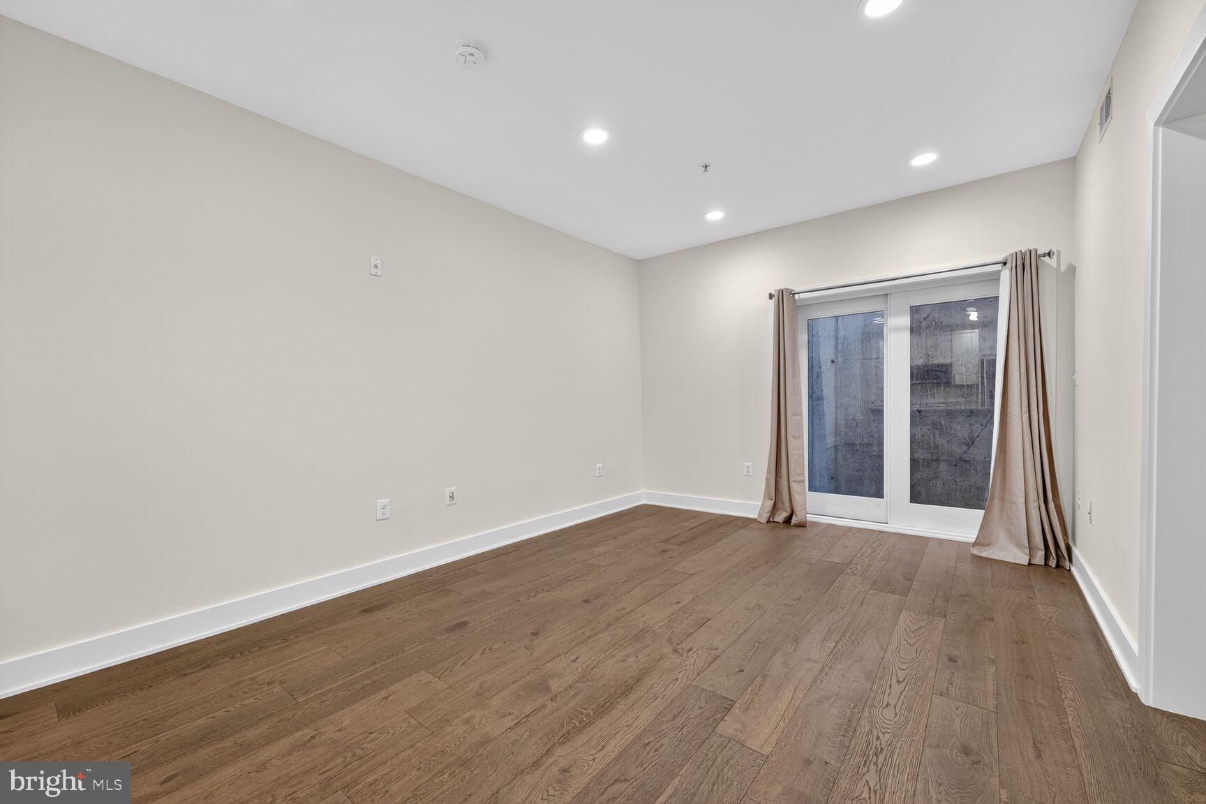 1412 Chapin Street Northwest, Unit 2 Washington, DC 20009 - Photo 6 of 15 a view of an empty room with wooden floor and a window