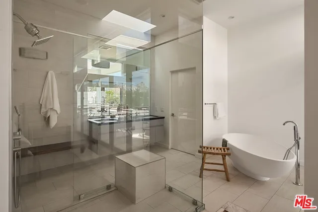 a bathroom with a bathtub and a shower