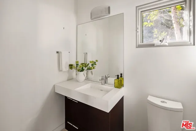 a bathroom with a sink toilet and vanity