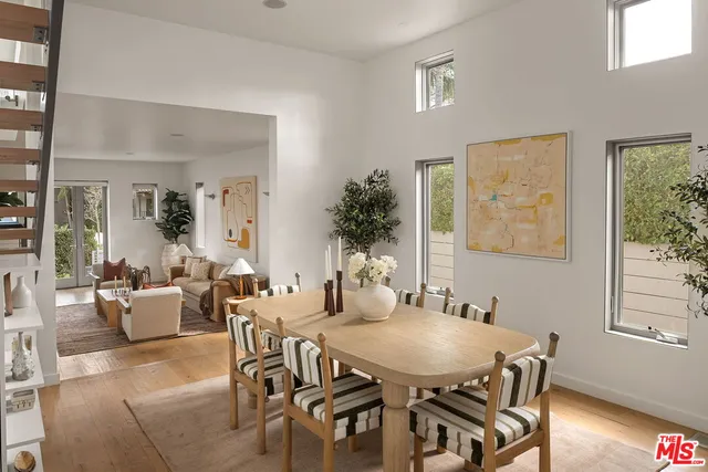 a view of a dining room with furniture and a potted plant