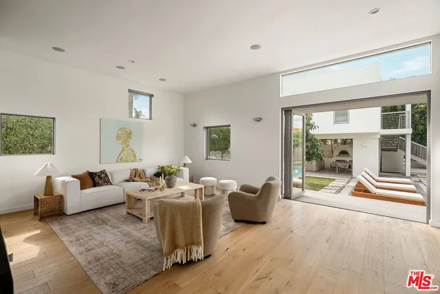 a living room with furniture and large windows