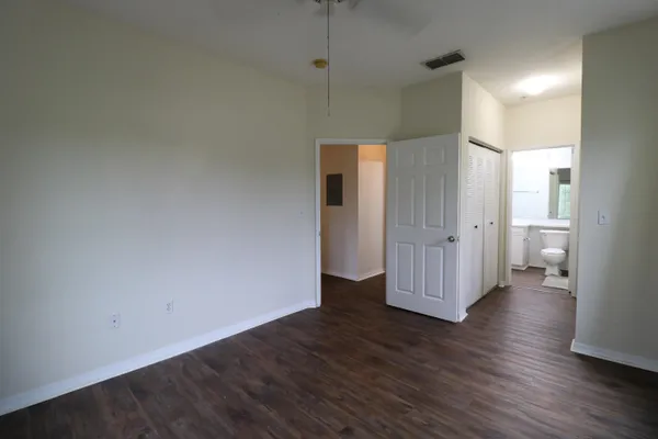 a view of a room with wooden floor