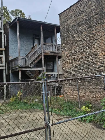 a front view of a house with plants