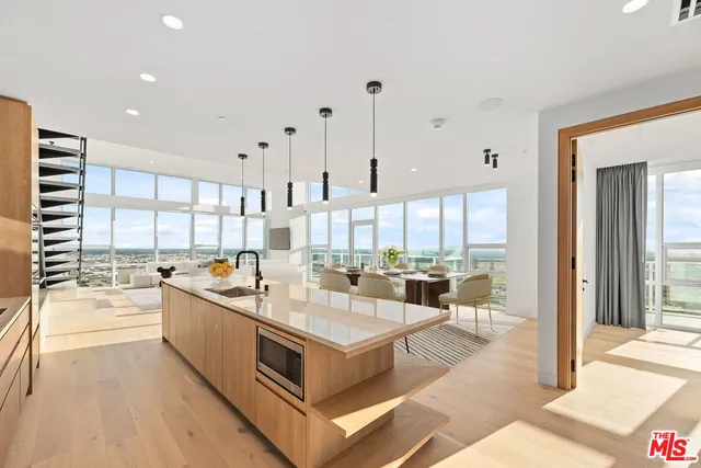 a dining room with furniture and a large window