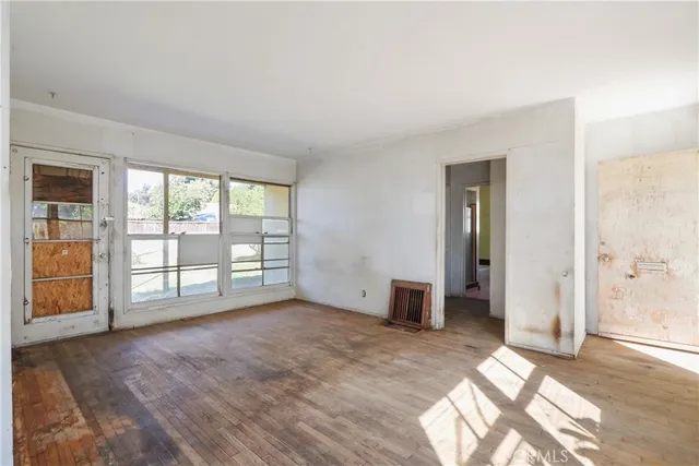 a view of an empty room with glass door