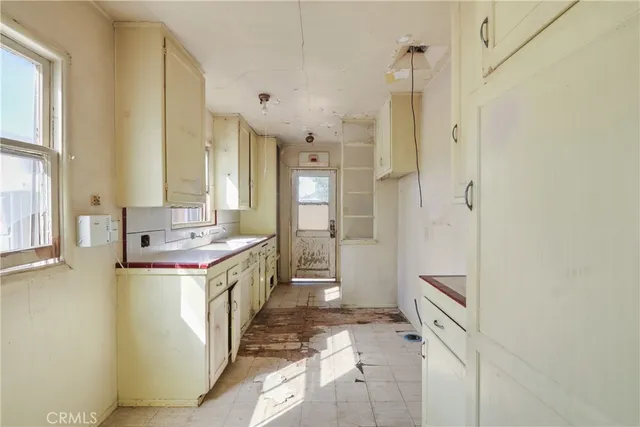 a large bathroom with a double vanity sink a large mirror and a bathtub