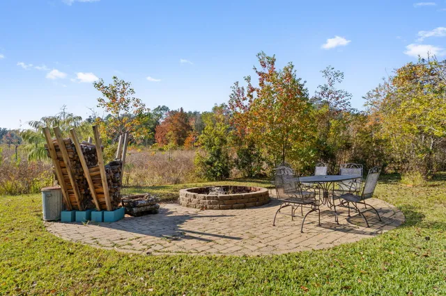 a view of a house with backyard and sitting area