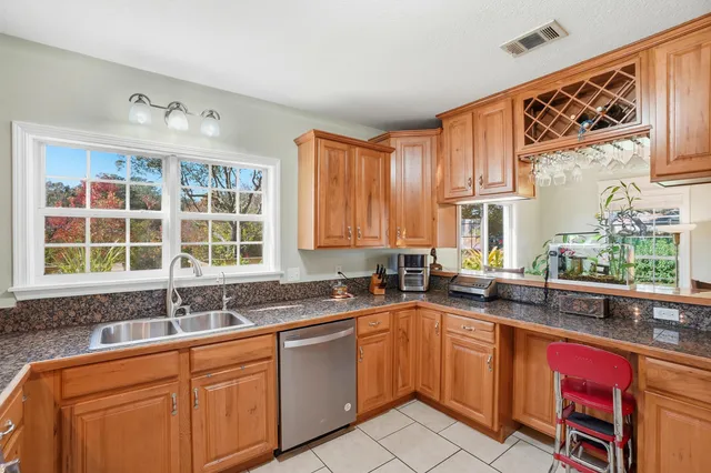 a kitchen with stainless steel appliances granite countertop a refrigerator stove and cabinets