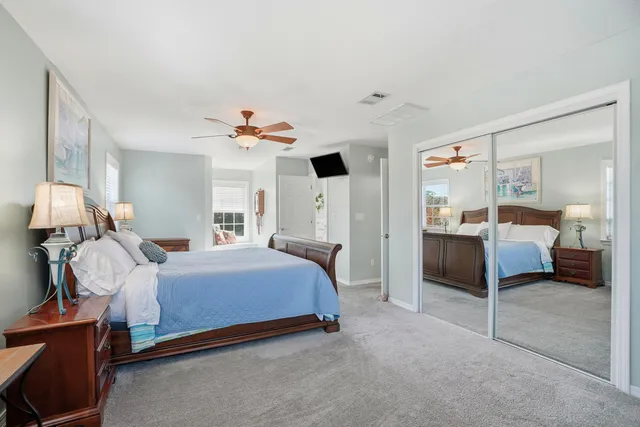 a bathroom with a granite countertop shower a sink and a mirror