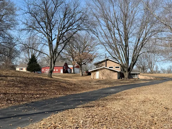 a view of a house with a yard covered with snow