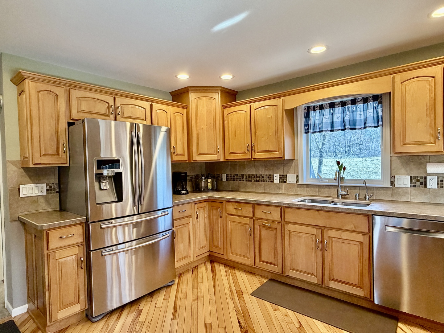 21186 Mathew Road Sterling, IL 61081 - Photo 13 of 66 a kitchen with stainless steel appliances granite countertop a refrigerator a sink dishwasher a stove and white cabinets with wooden floor