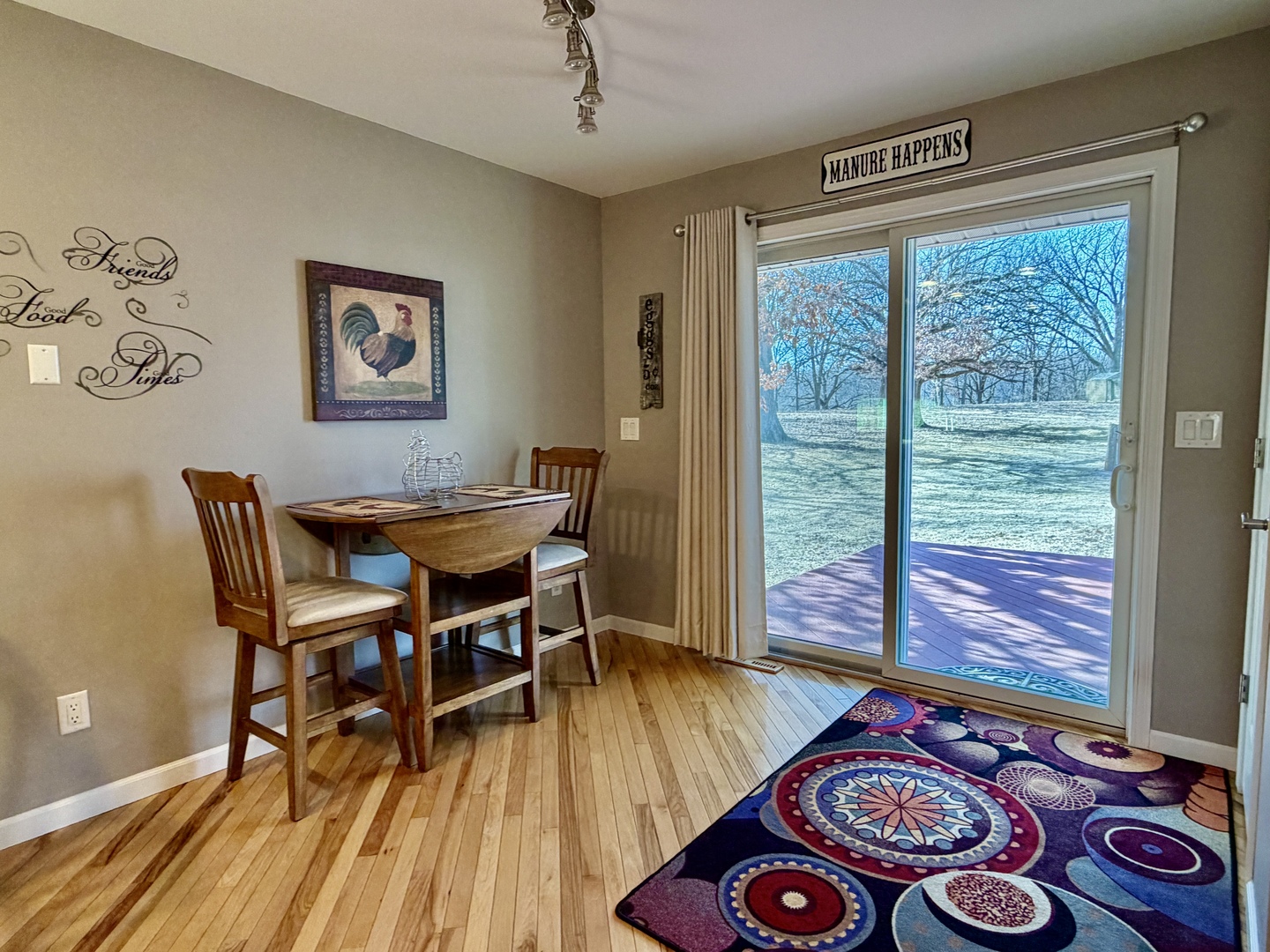 21186 Mathew Road Sterling, IL 61081 - Photo 16 of 66 a dining room with wooden floor and a table