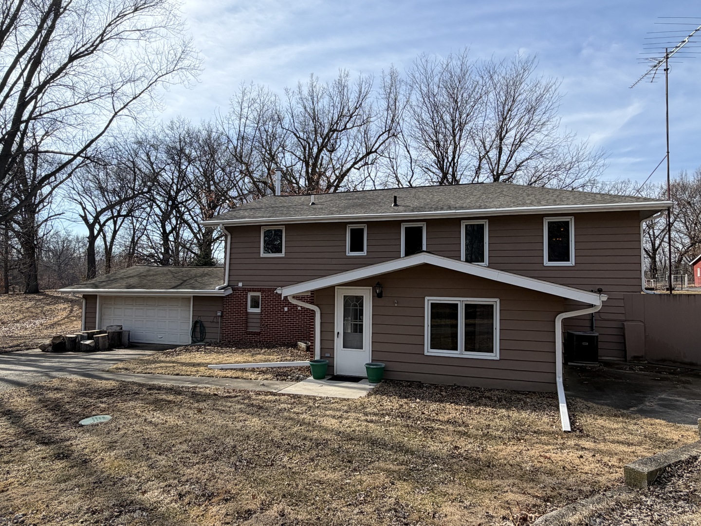 21186 Mathew Road Sterling, IL 61081 - Photo 2 of 66 a front view of a house with a yard and garage