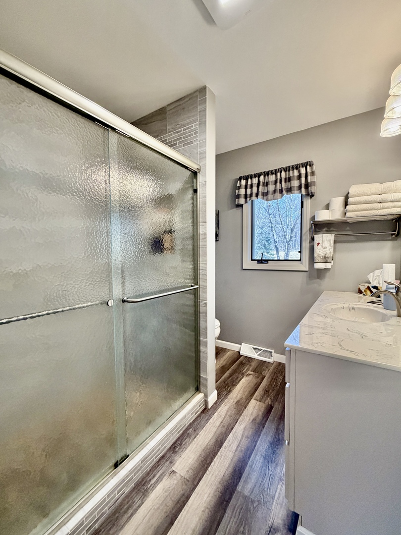 21186 Mathew Road Sterling, IL 61081 - Photo 22 of 66 a bathroom with a granite countertop sink a mirror and shower