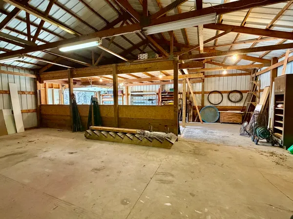 a view of dirt yard with a large tree