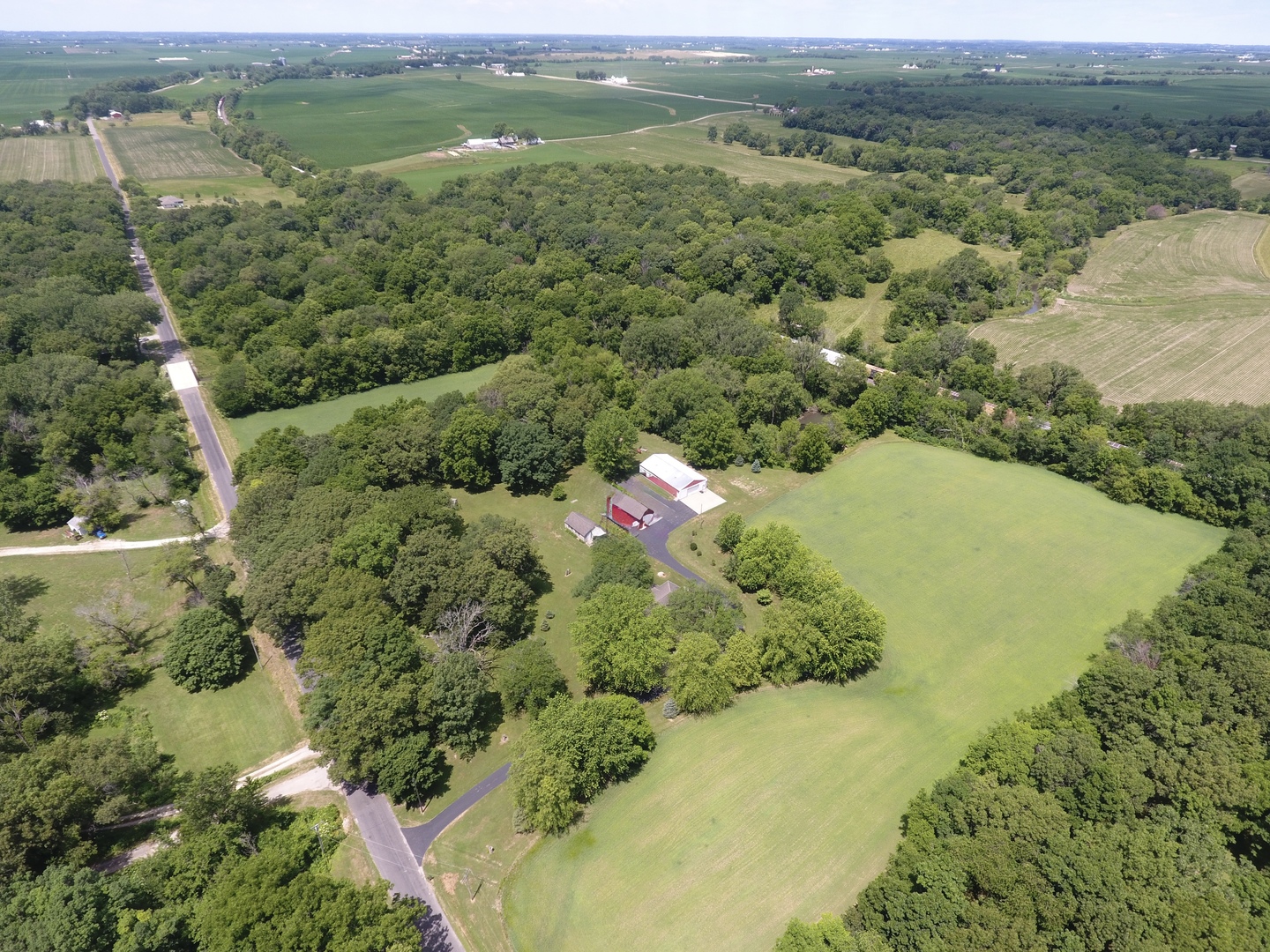 21186 Mathew Road Sterling, IL 61081 - Photo 65 of 66 a view of a lush green field with lots of green plants and trees in the background