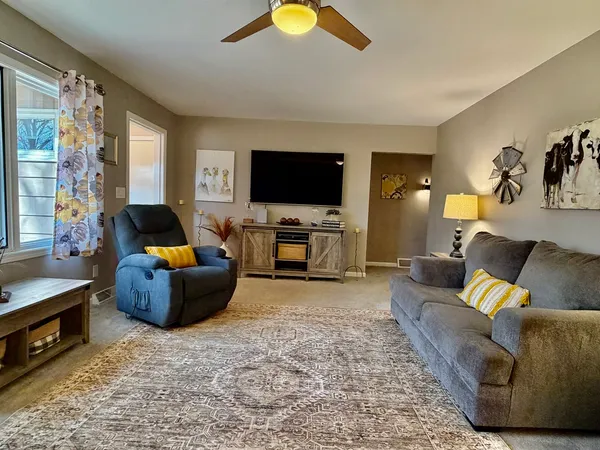 a living room with furniture and a large window