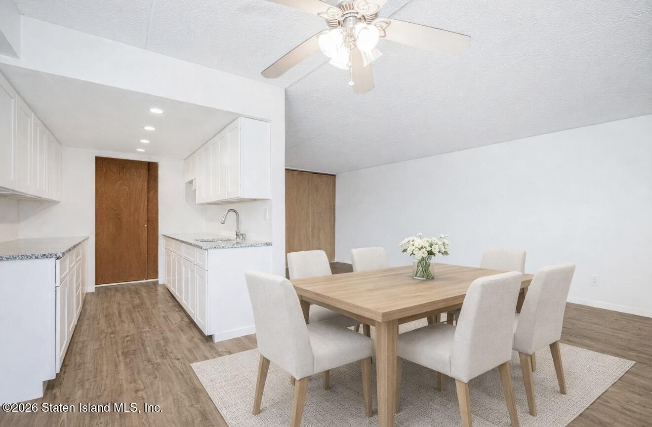 5 Windham Loop, Unit 6E Staten Island, NY 10314 - Photo 12 of 25 a view of a dining room with furniture and wooden floor