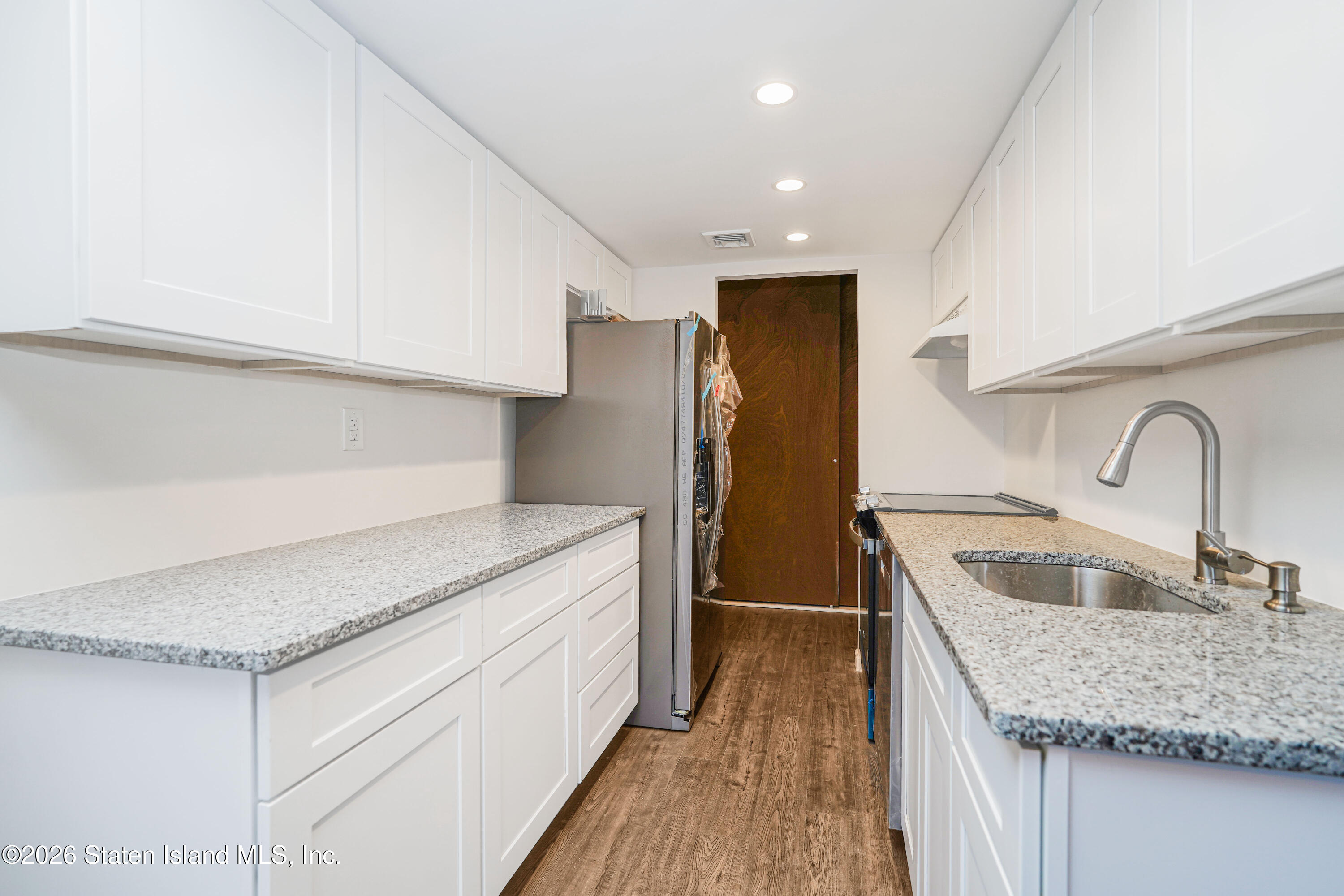 5 Windham Loop, Unit 6E Staten Island, NY 10314 - Photo 14 of 25 a kitchen with granite countertop a sink and refrigerator
