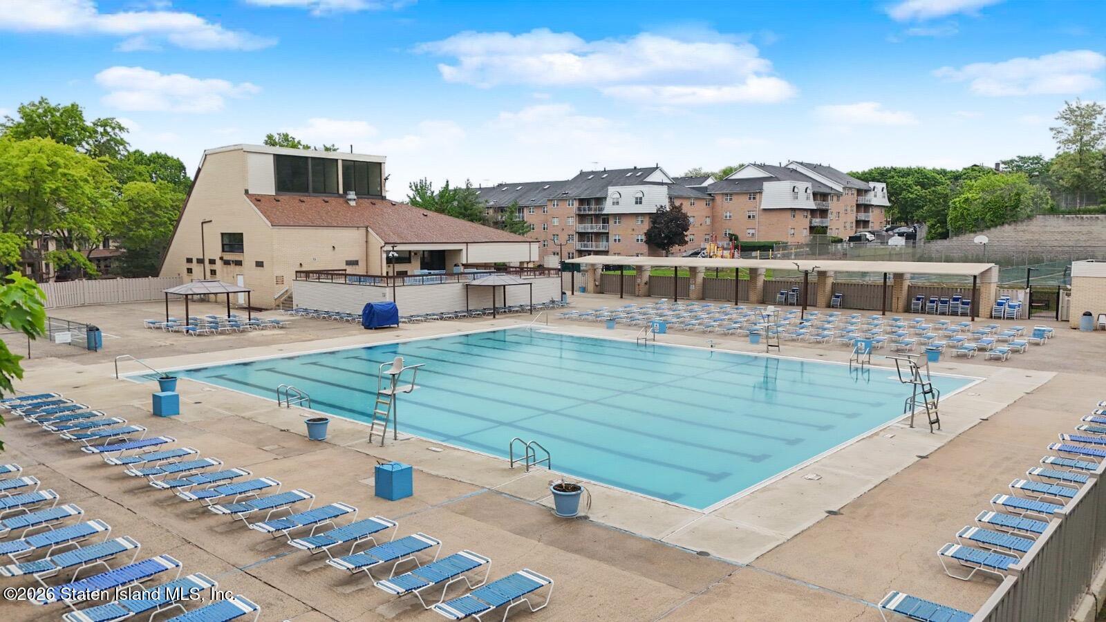 5 Windham Loop, Unit 6E Staten Island, NY 10314 - Photo 24 of 25 a view of a swimming pool with a lounge chairs