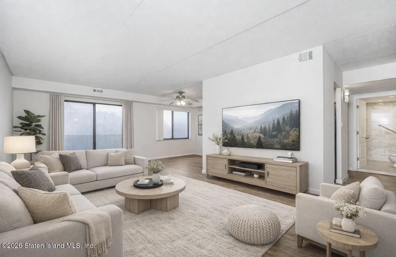 5 Windham Loop, Unit 6E Staten Island, NY 10314 - Photo 6 of 25 a living room with furniture and a flat screen tv