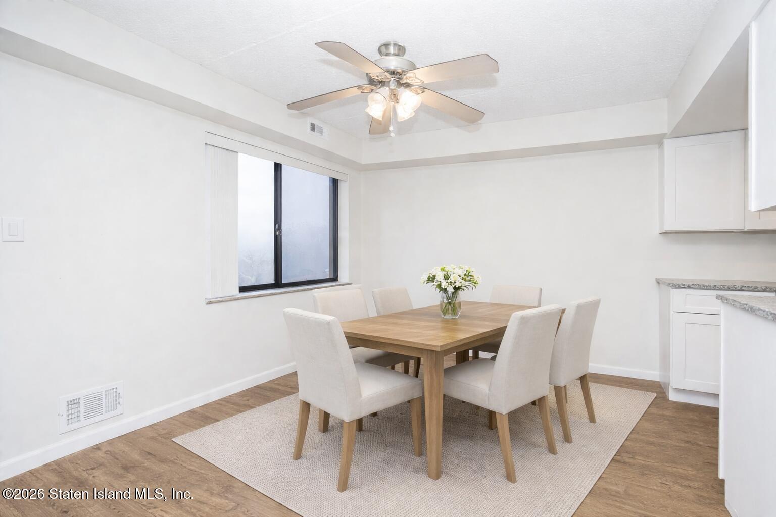 5 Windham Loop, Unit 6E Staten Island, NY 10314 - Photo 10 of 25 a view of a dining room with furniture and wooden floor