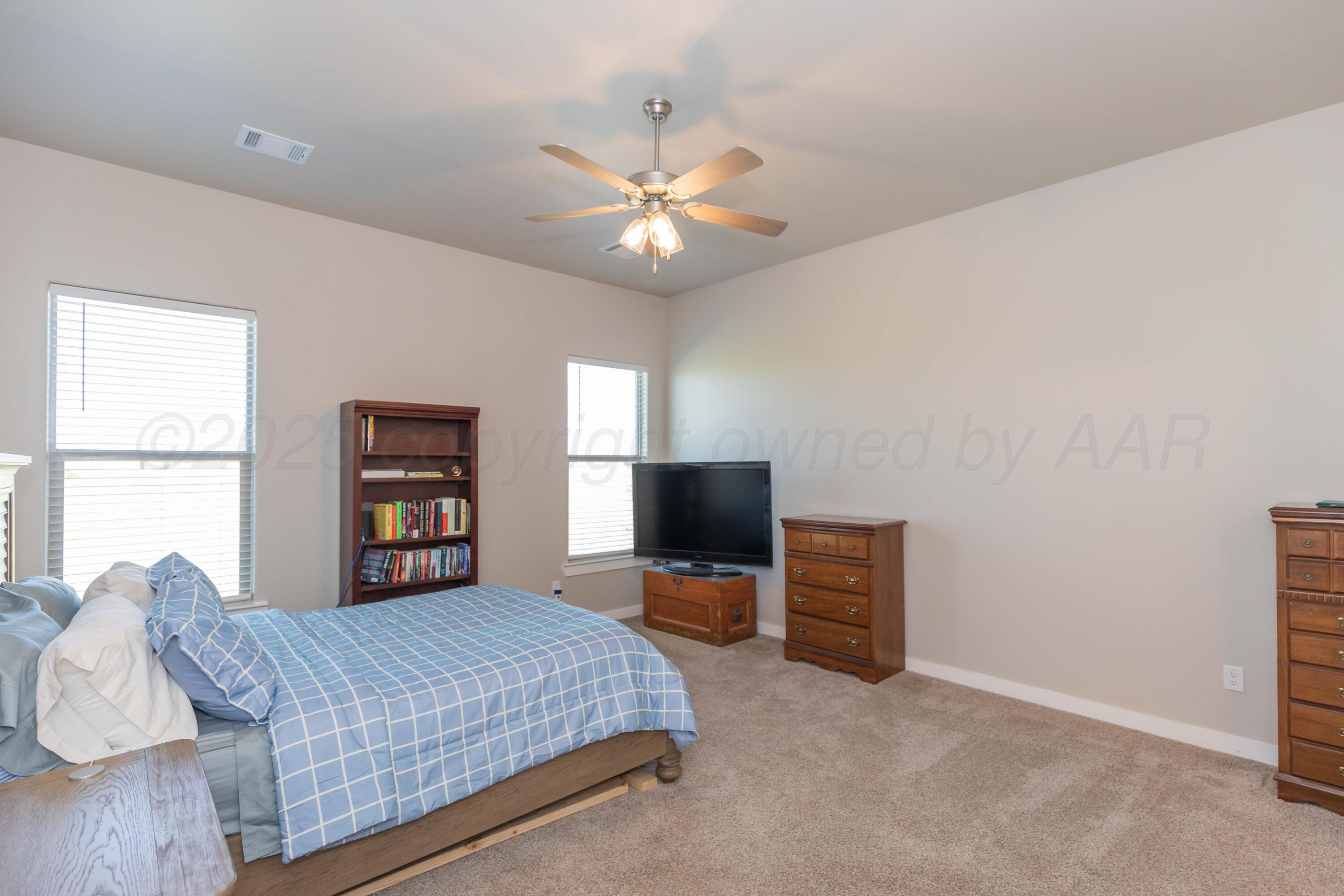 2600 Daybreak Lane Amarillo, TX 79124 - Photo 25 of 52 a bedroom with a bed and a flat screen tv