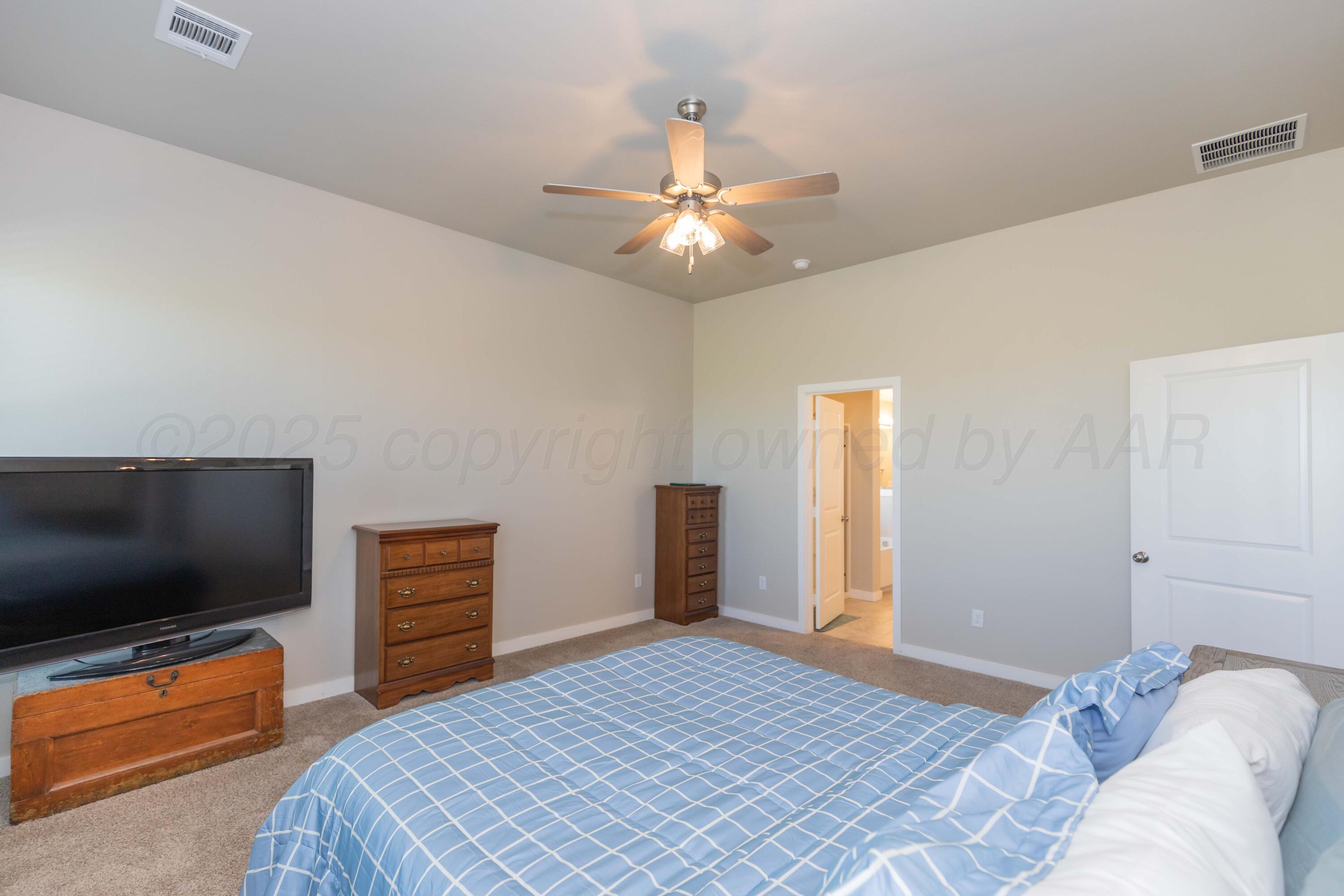 2600 Daybreak Lane Amarillo, TX 79124 - Photo 26 of 52 a bedroom with a bed and a flat screen tv