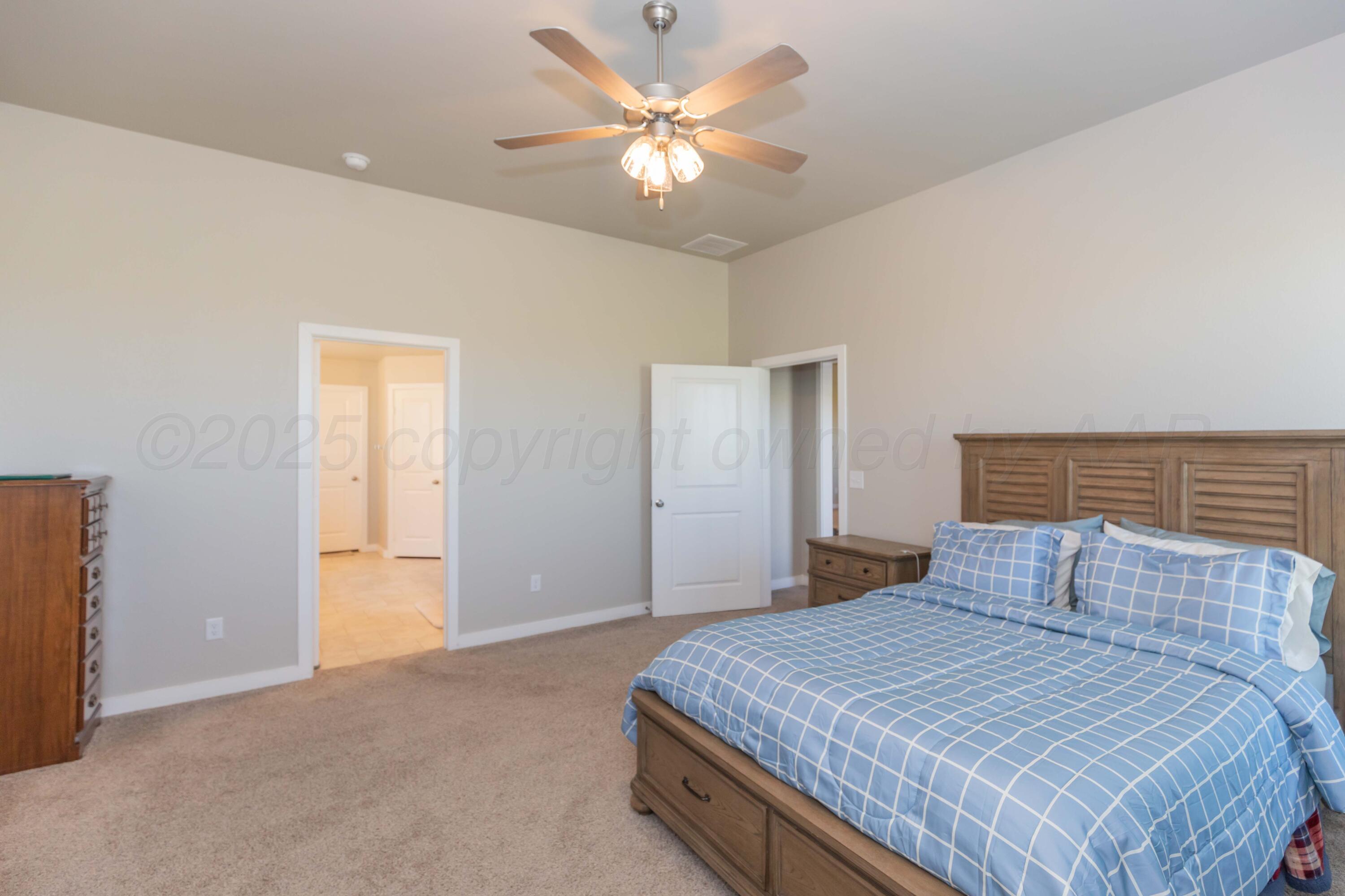 2600 Daybreak Lane Amarillo, TX 79124 - Photo 27 of 52 a bedroom with a bed and a ceiling fan