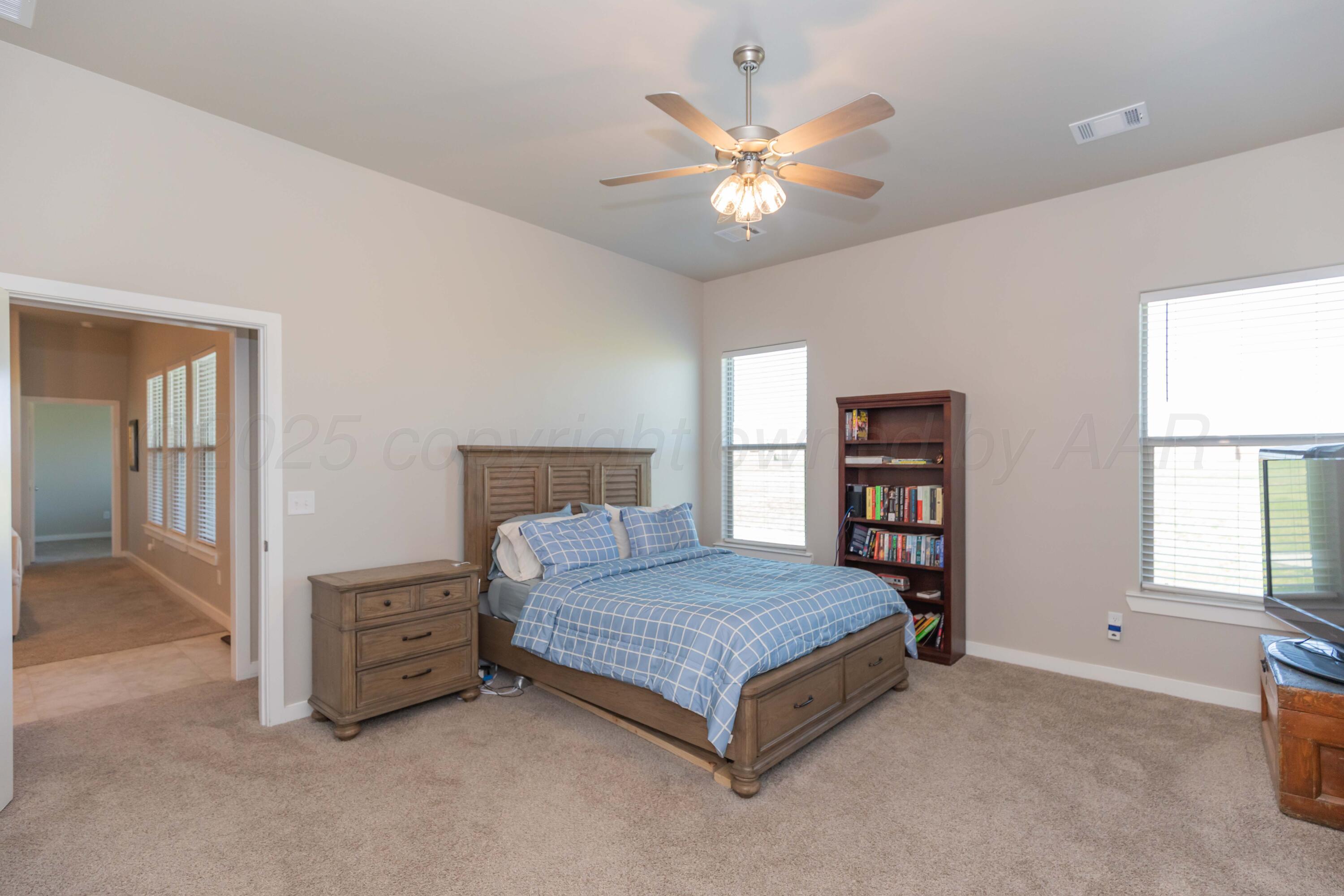 2600 Daybreak Lane Amarillo, TX 79124 - Photo 28 of 52 a bedroom with a bed chandelier and a window