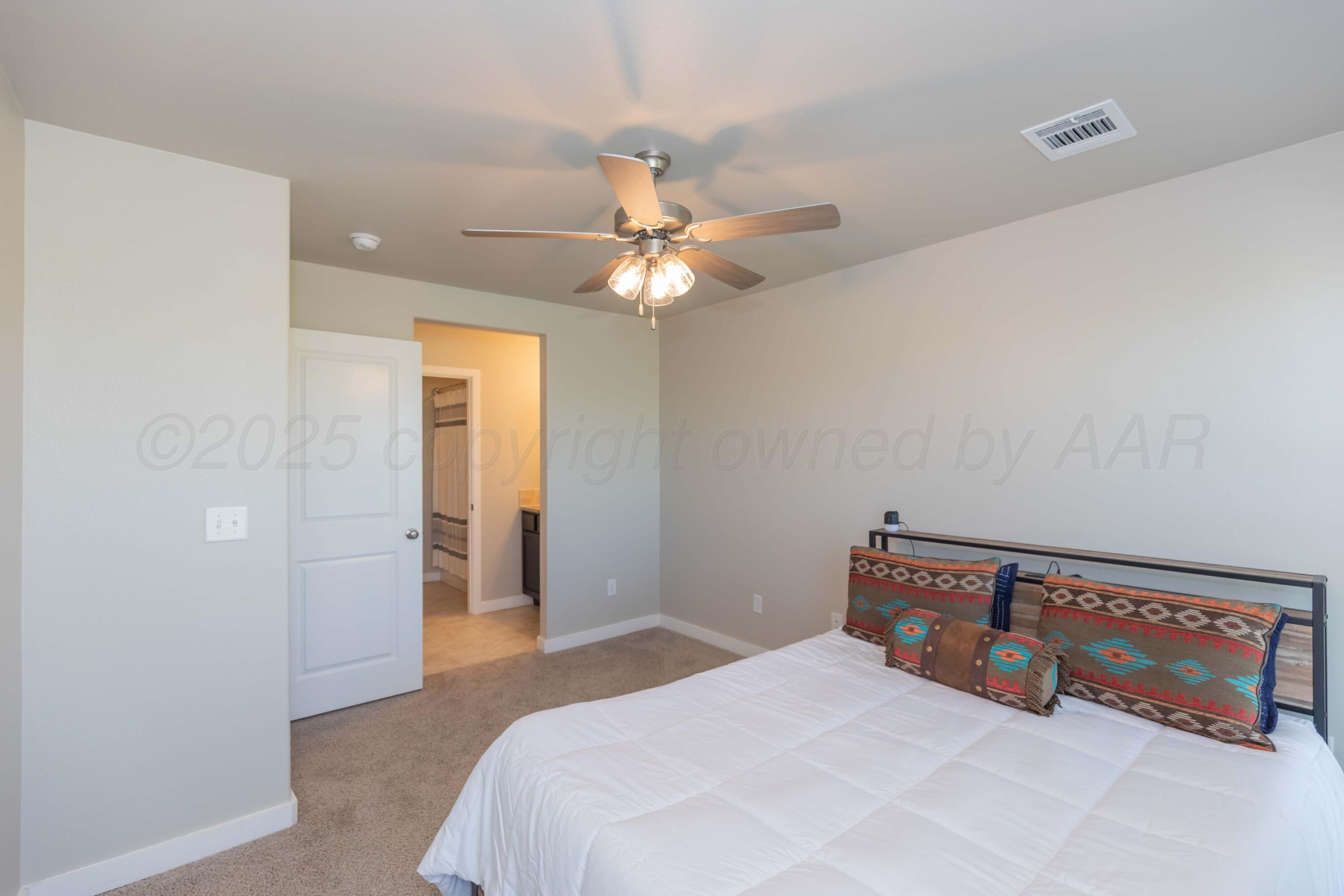 2600 Daybreak Lane Amarillo, TX 79124 - Photo 34 of 52 a bedroom with a bed and a ceiling fan