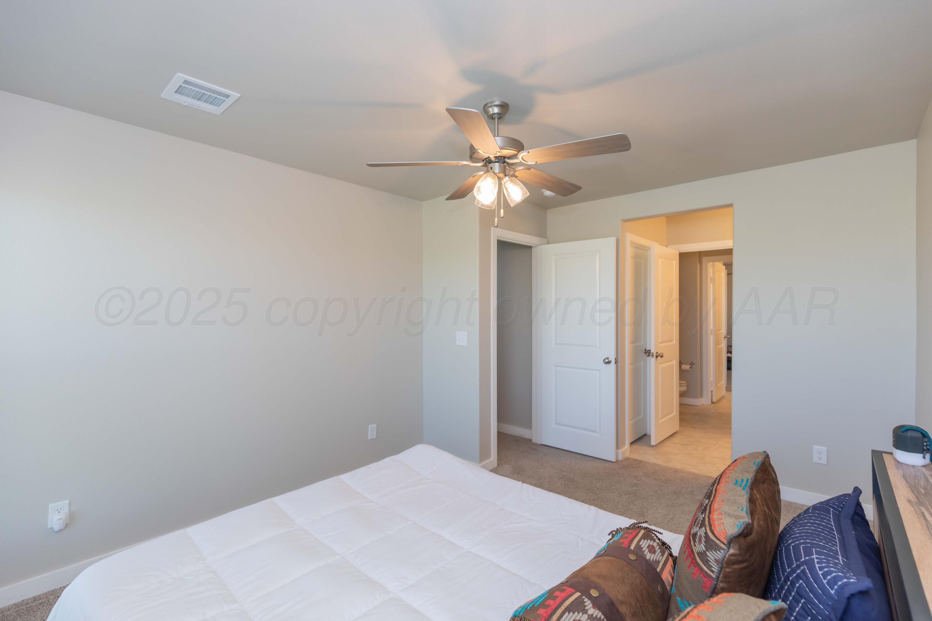 2600 Daybreak Lane Amarillo, TX 79124 - Photo 35 of 52 a bedroom with a bed chandelier and a window