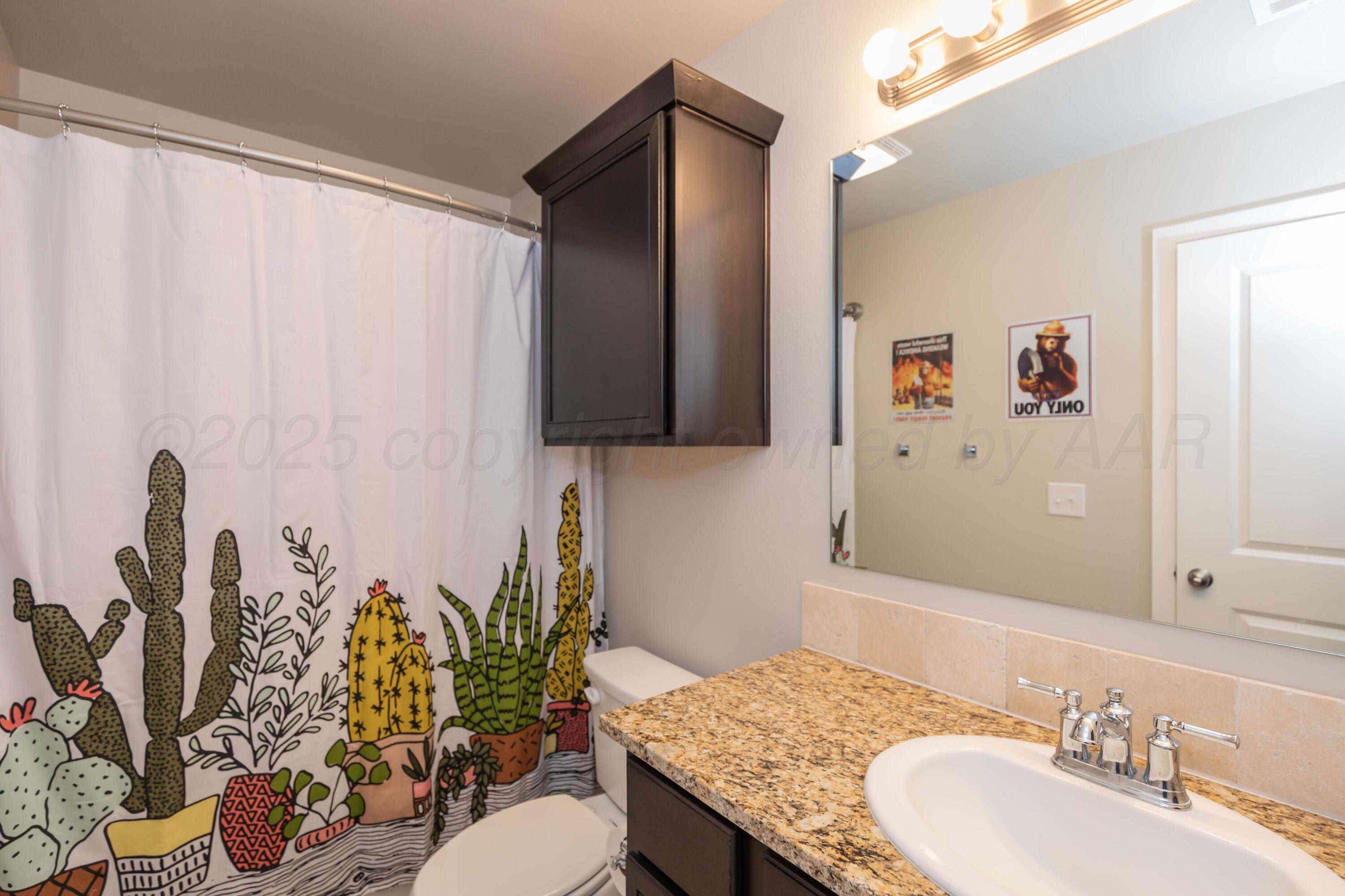2600 Daybreak Lane Amarillo, TX 79124 - Photo 36 of 52 a bathroom with a granite countertop sink and a mirror