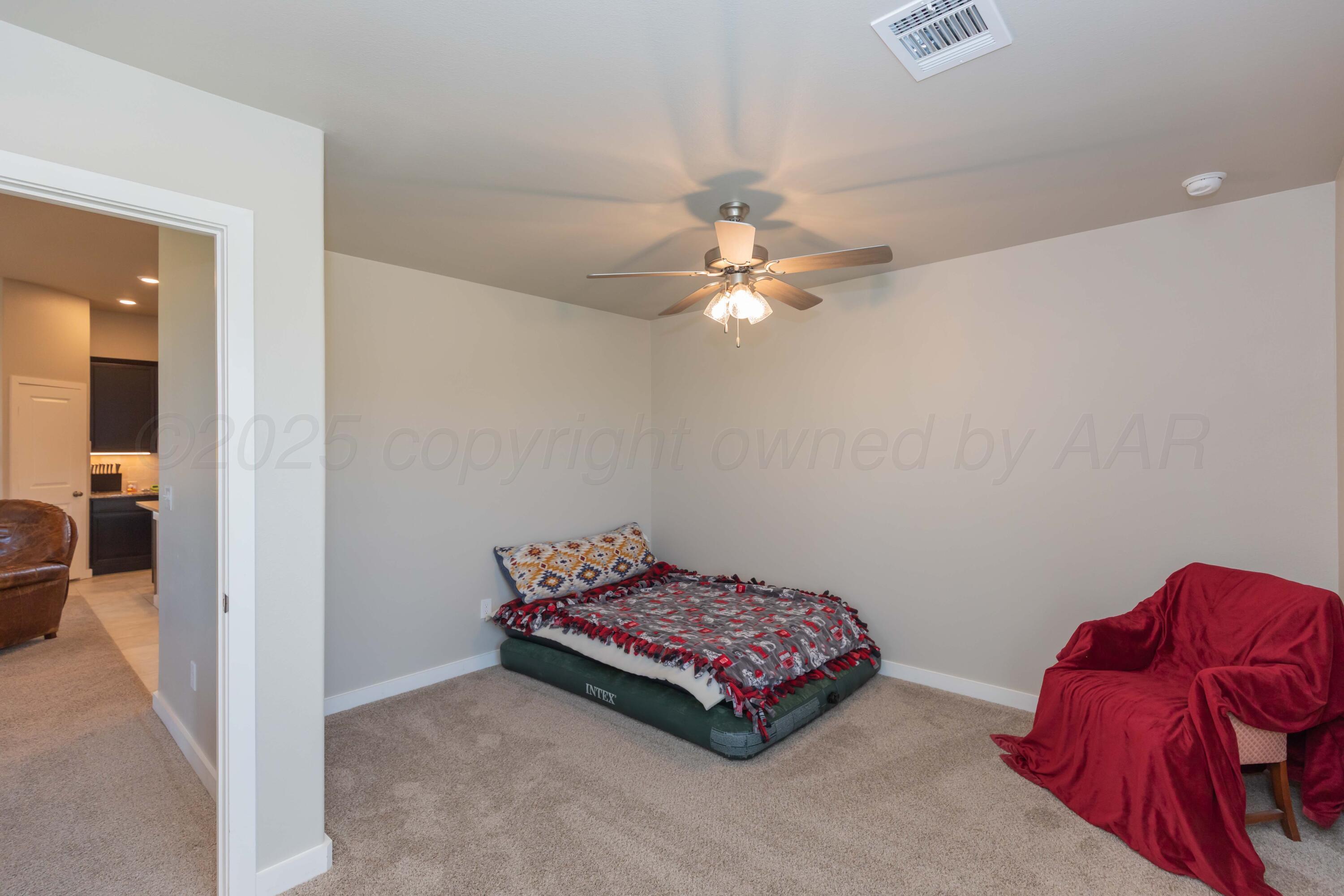 2600 Daybreak Lane Amarillo, TX 79124 - Photo 38 of 52 a bedroom with a bed and a chandelier