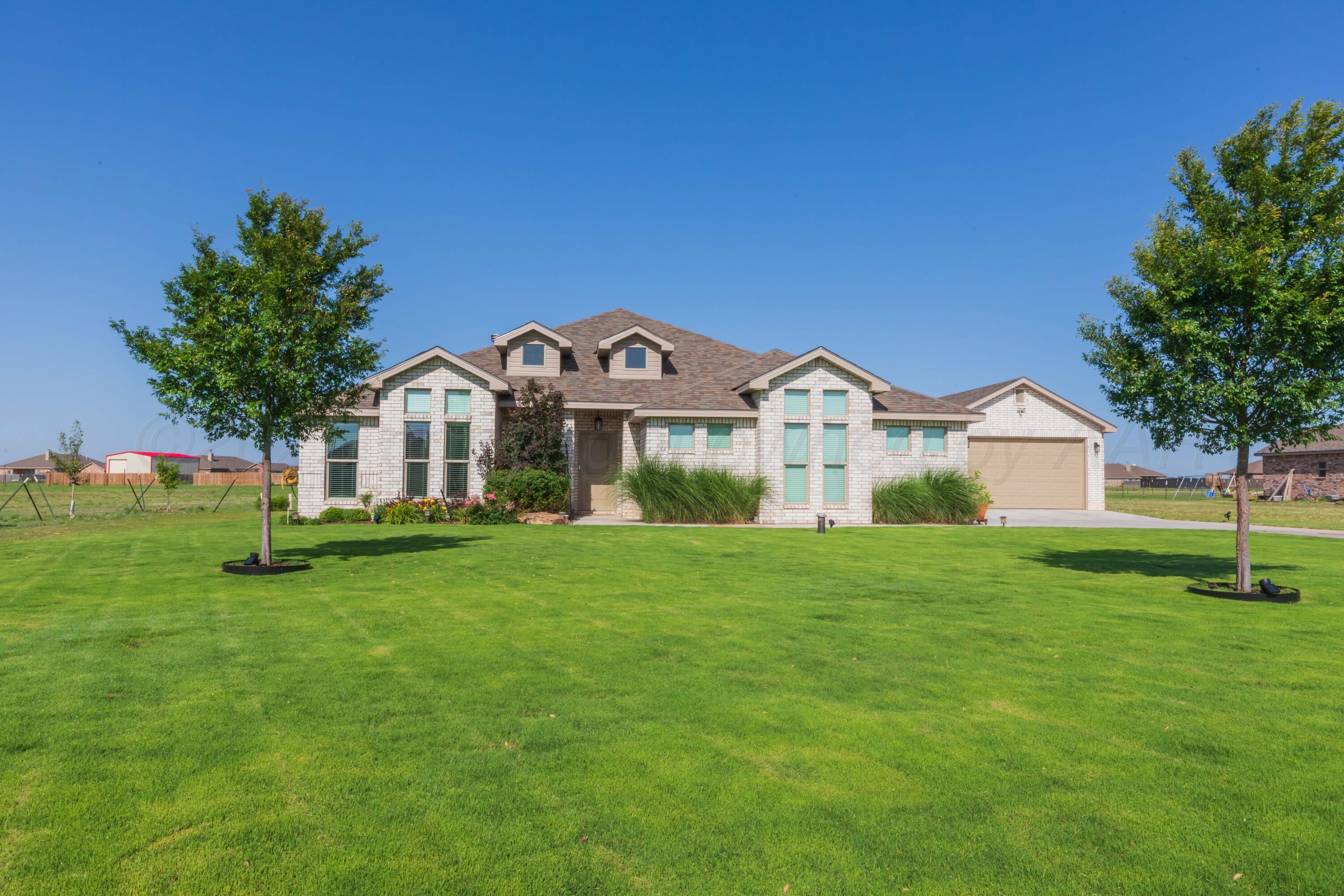 2600 Daybreak Lane Amarillo, TX 79124 - Photo 4 of 52 a front view of a house with a garden