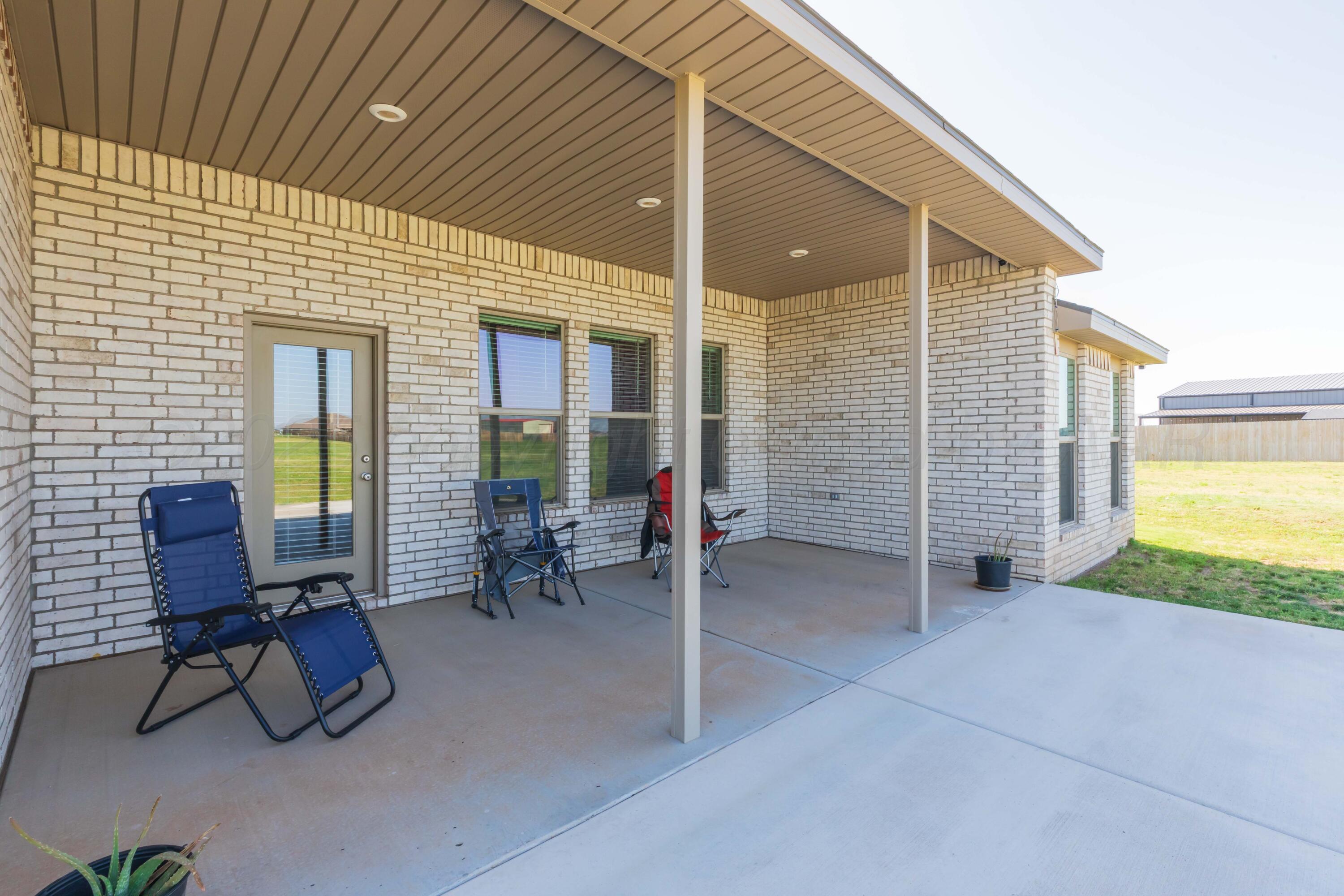2600 Daybreak Lane Amarillo, TX 79124 - Photo 46 of 52 a view of a patio with table and chairs and wooden fence