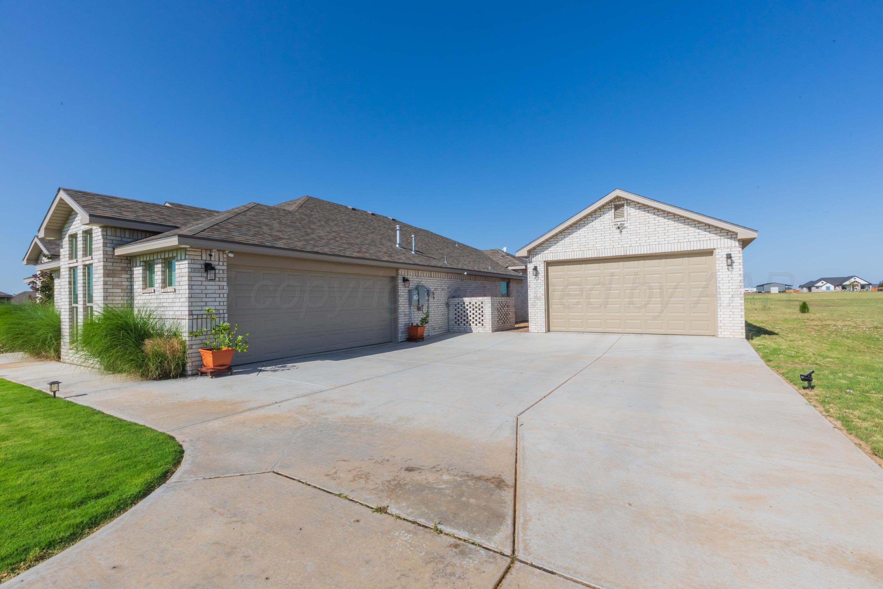 2600 Daybreak Lane Amarillo, TX 79124 - Photo 5 of 52 a front view of a house with a yard and garage