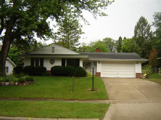 522 Wood Road Rockford, IL 61107 - Photo 1 of 1 a front view of house with a garden and trees