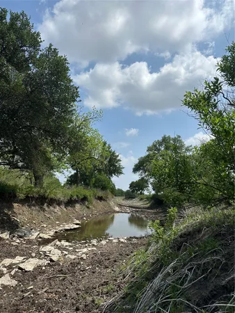 a view of a lake in between two of trees