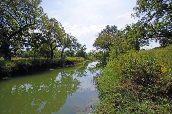 a view of lake with green space